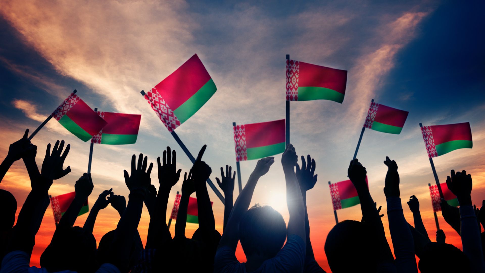 Hands raised up towards the sky holding Belarus flags