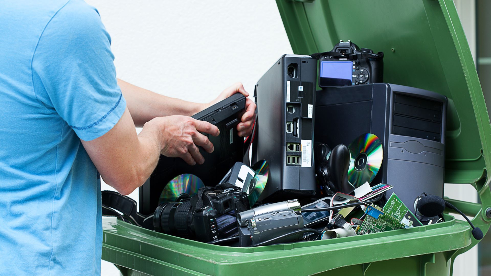 Image of man throwing away electronics