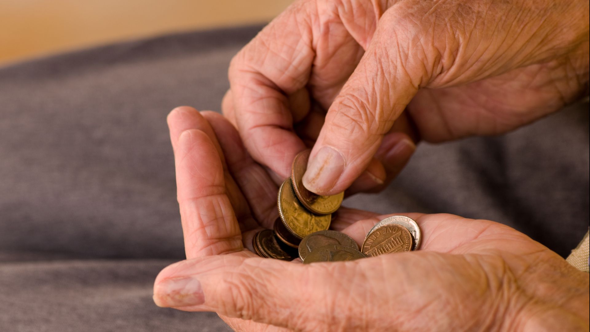 old person's hands counting money