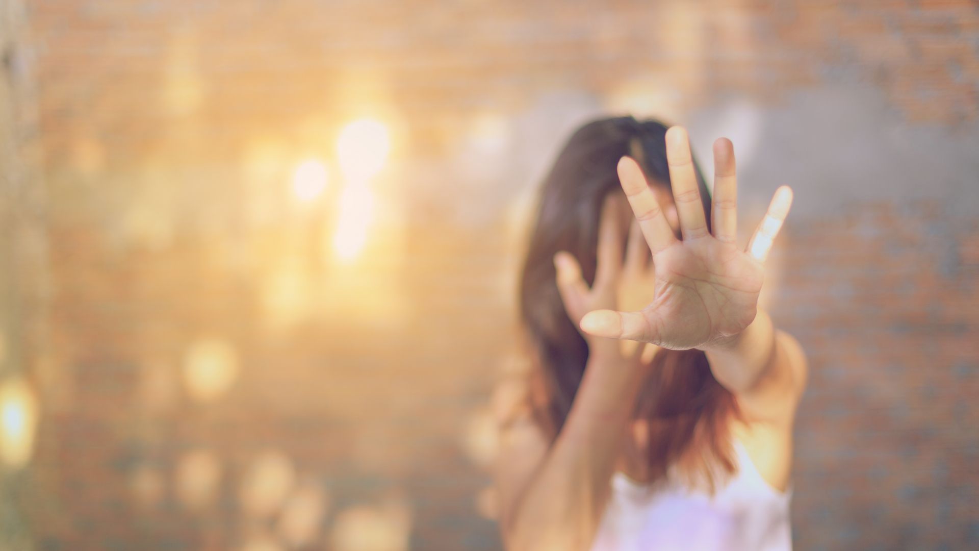 women holding out hand against violence