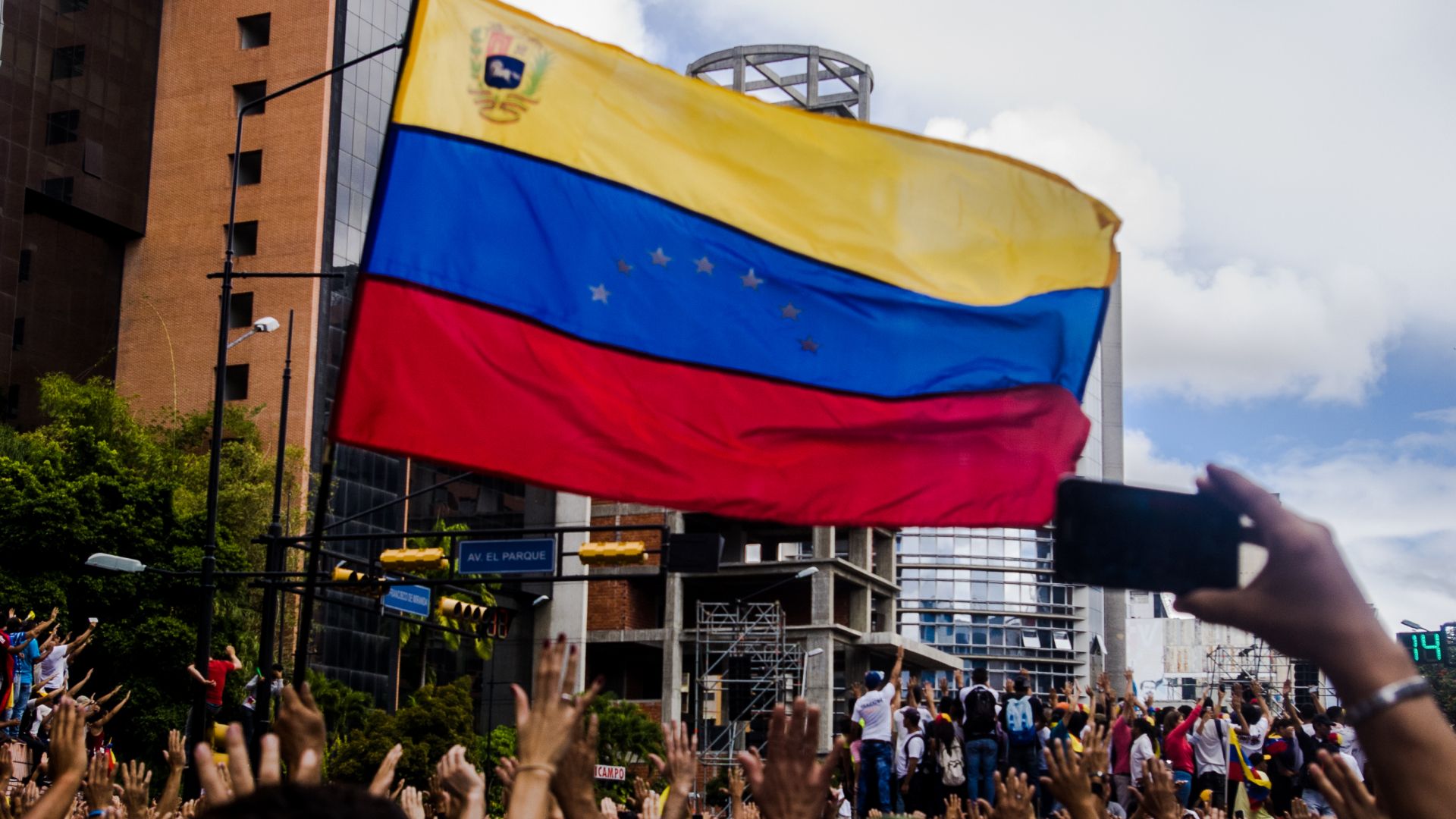 Venezuela flag and people protesting