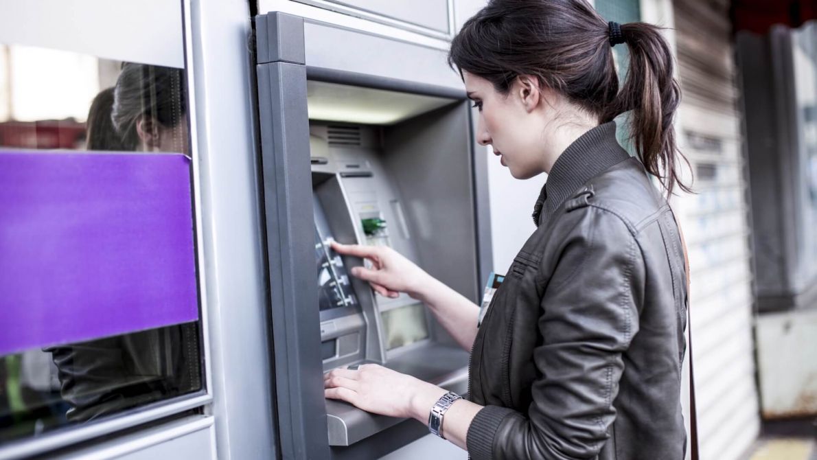 Woman conducting a transaction in an ATM machine