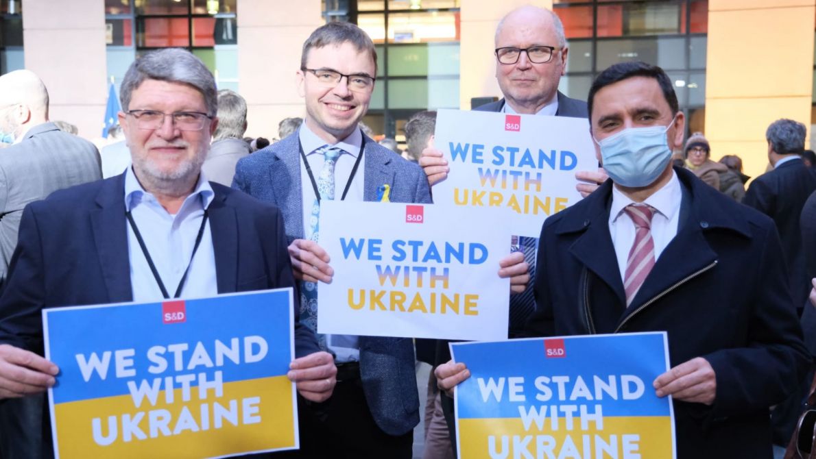 MEPs holding sign that says We Stand with Ukraine