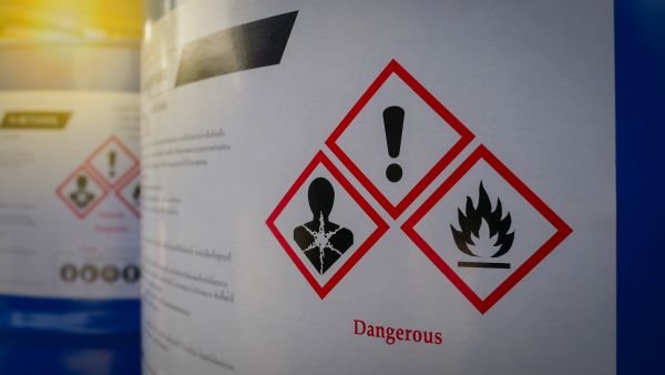 chemical tanks with hazard warnings displayed on them