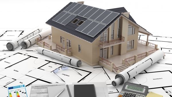 An architect's model of an energy-efficient house with solar panels