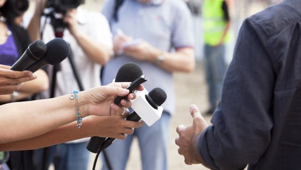 Journalists recording interview