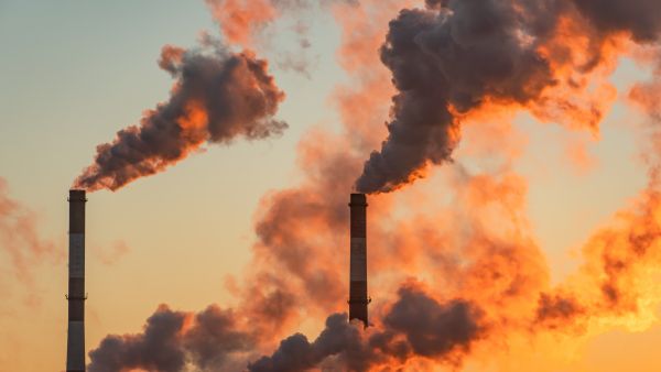 Factory chimneys send out plumes of smoke