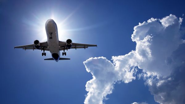 Passenger plane flying in blue sky