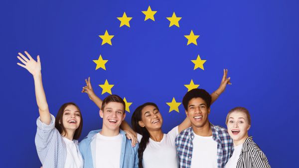Young people in front of an EU flag