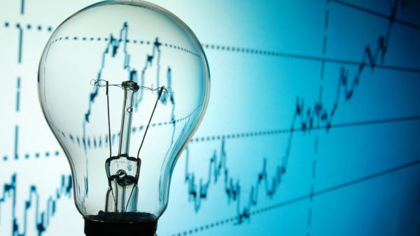 Light bulb with stocks and shares chart behind it