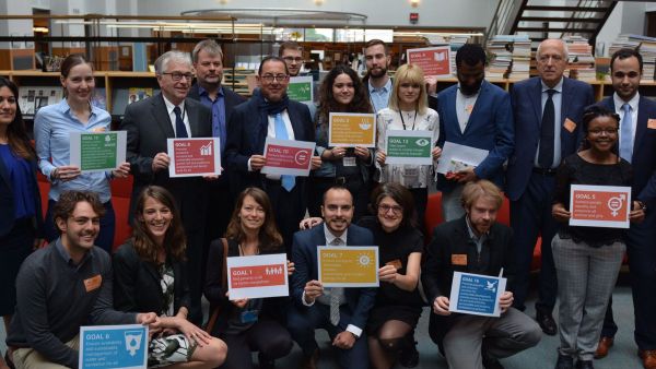 Progressive sustainable development book launch with Gianni Pittella, Ernst Stetter, Conny Reuter and colleagues holding banners of the SDGs 
