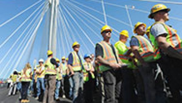 male industry workers lining up for a job