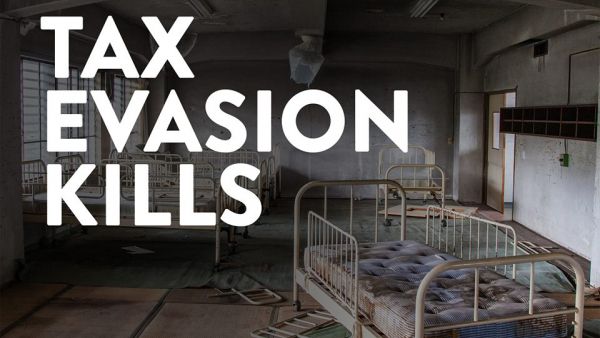 Derelict hospital ward with banner tax evasion kills